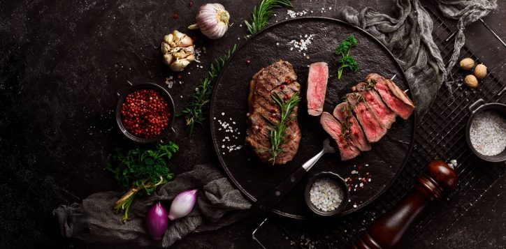 photo-grilled-ribeye-beef-steak-steak-fork-black-plate-top-view-black-stone-background-wide-2-2
